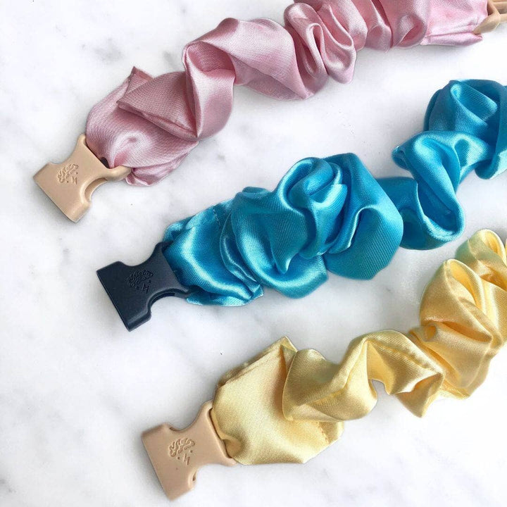 Set of colorful satin scrunchies on a white background