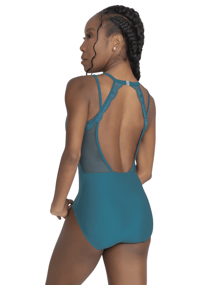 Woman wearing a teal swimsuit with open back on a white background