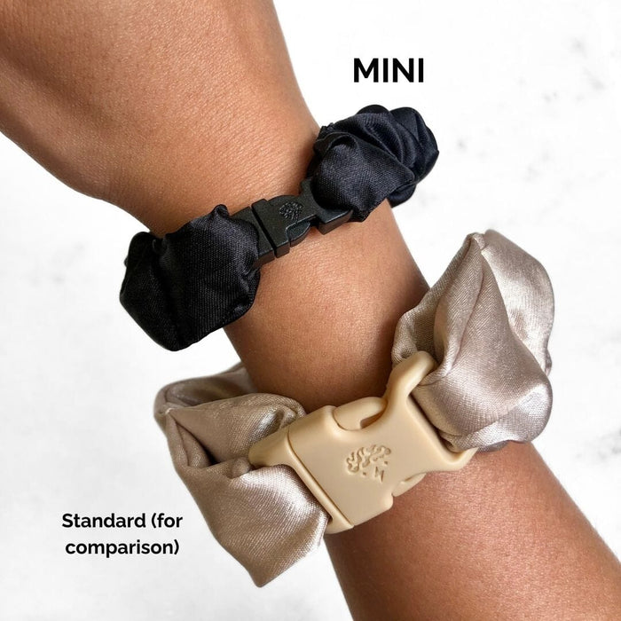 Two hair scrunchies, one black and one beige, on a wrist with 'MINI' and 'Standard' labels.