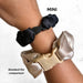 Two hair scrunchies, one black and one beige, on a wrist with 'MINI' and 'Standard' labels.