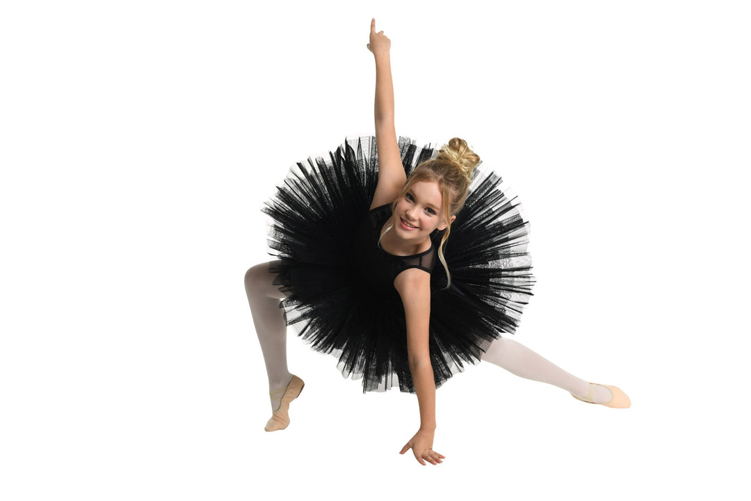 Ballerina in a black tutu posing on a white background