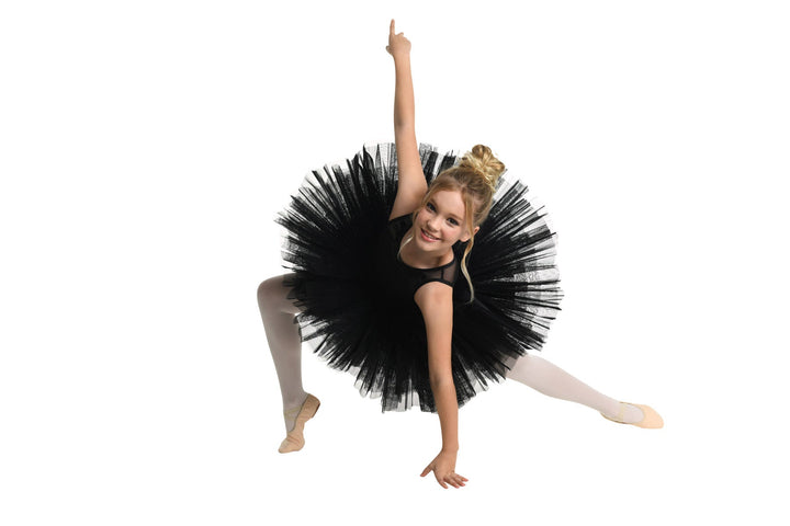 Ballerina in a black tutu posing on a white background