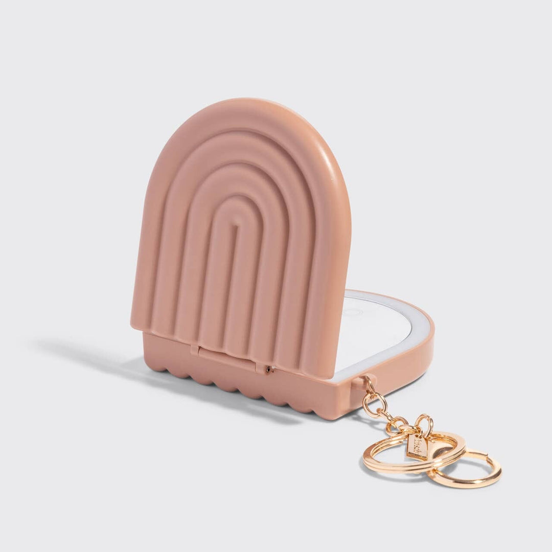 Pink ice cream-shaped keychain case with gold rings on a light gray background