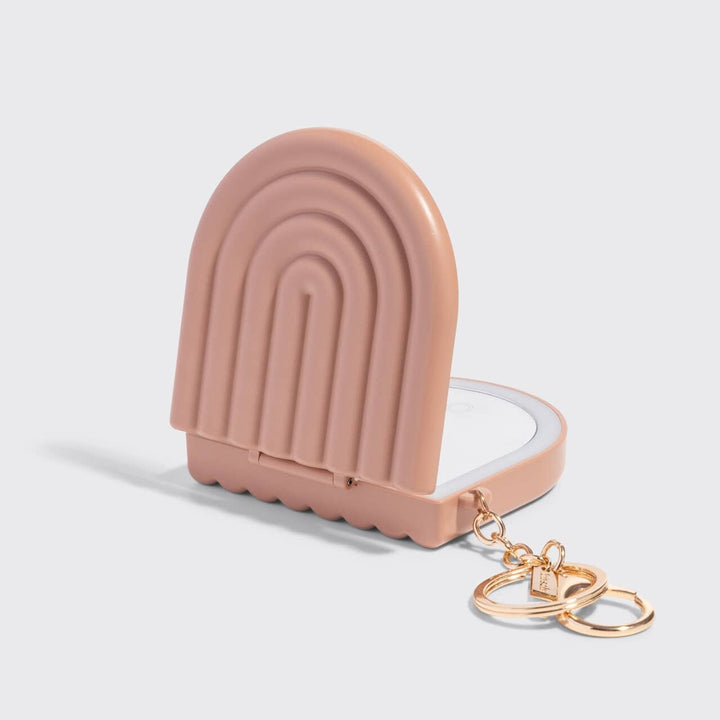 Pink ice cream-shaped keychain case with gold rings on a light gray background