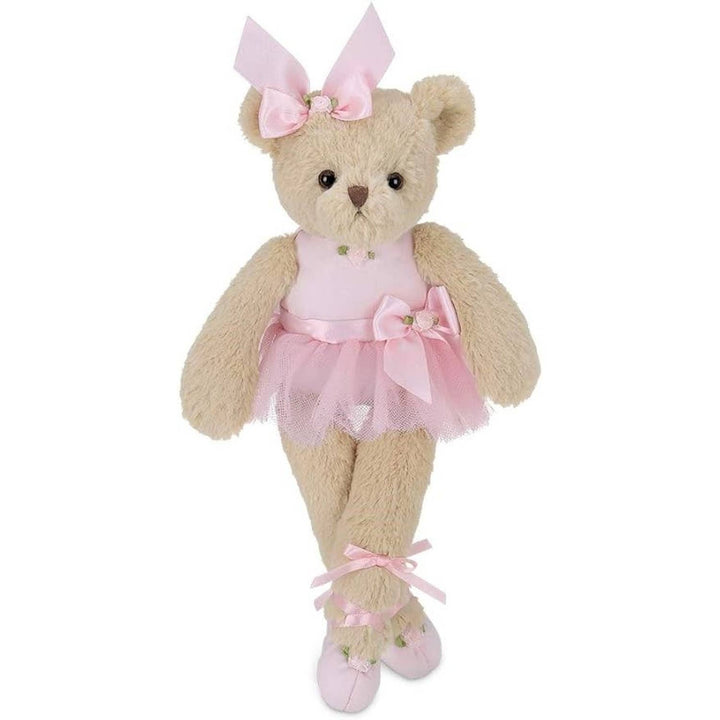 Plush teddy bear in a pink ballet outfit with a bow on a white background