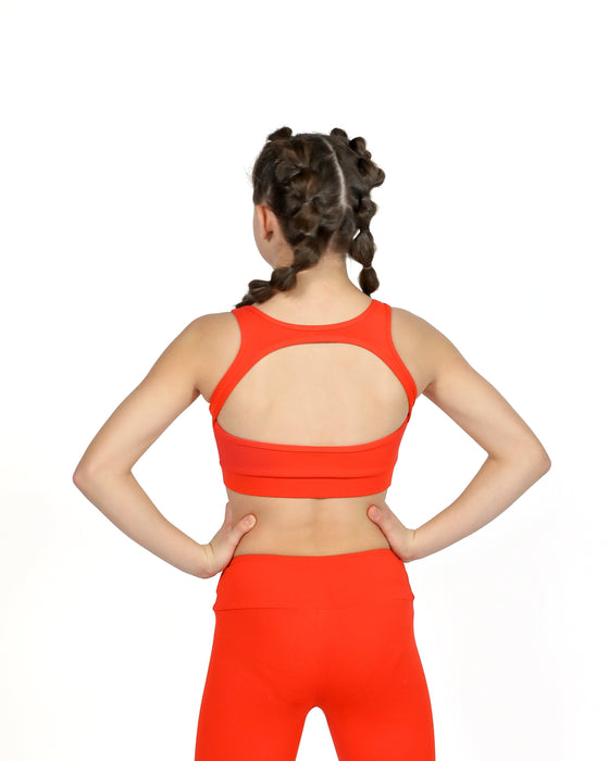 Person wearing a bright orange sports bra and leggings on a white background