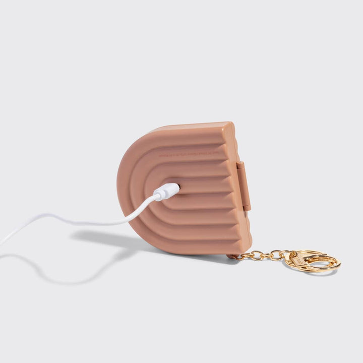 Pink air pod case with white cable on a light gray background