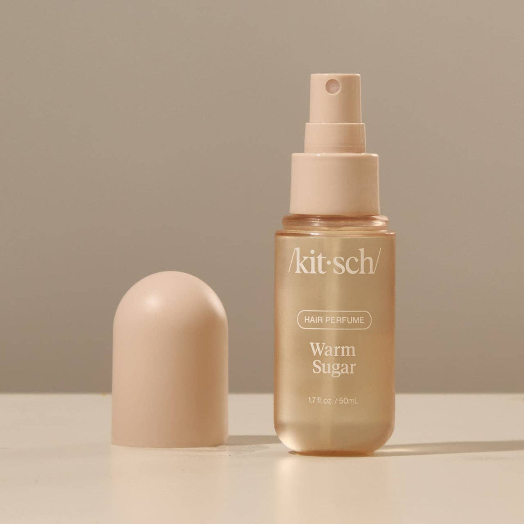 Kitsch hair perfume bottle with cap on a beige background