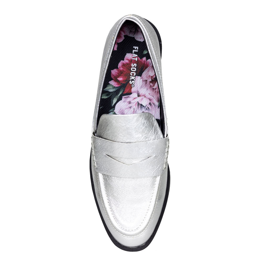 Silver loafer shoe with floral design on the insole on a white background