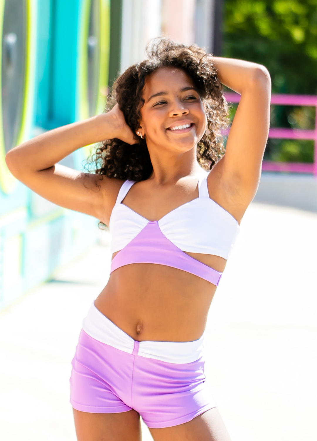 Woman wearing a colorful sports outfit with a blurred outdoor background
