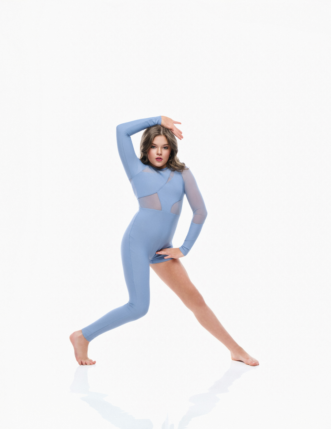 Woman wearing a blue bodysuit on a white background