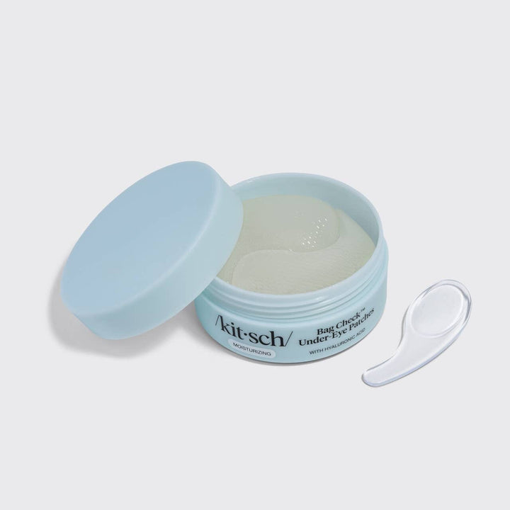 Kit-sch eye patch container with a spoon on a light gray background