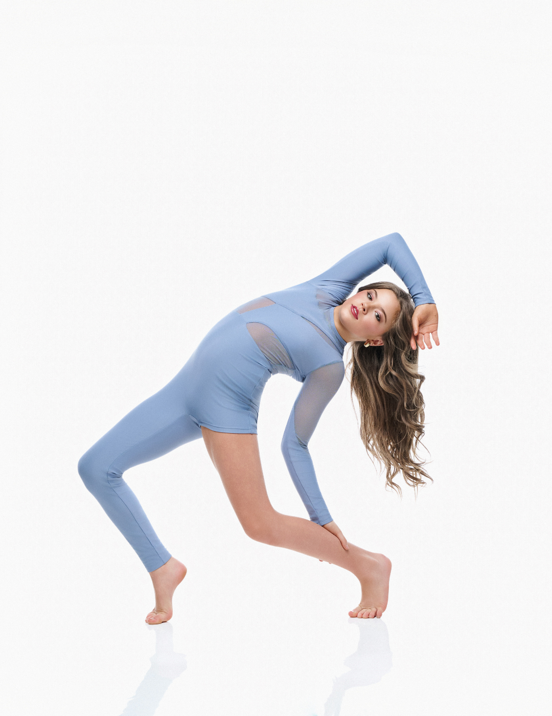 Woman wearing a blue bodysuit on a white background