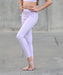 Person wearing light purple leggings on a gray pavement background