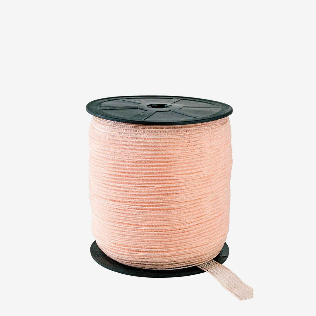 Spool of pink ribbon on a white background