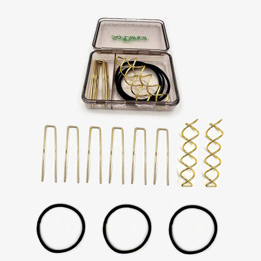 Set of hair styling tools including bobby pins, hair rings, and clips in a clear container on a white background.