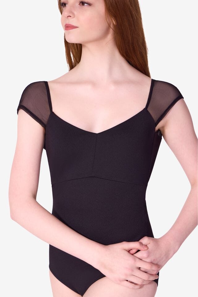 Black bodysuit with sheer sleeves worn by a model on a white background