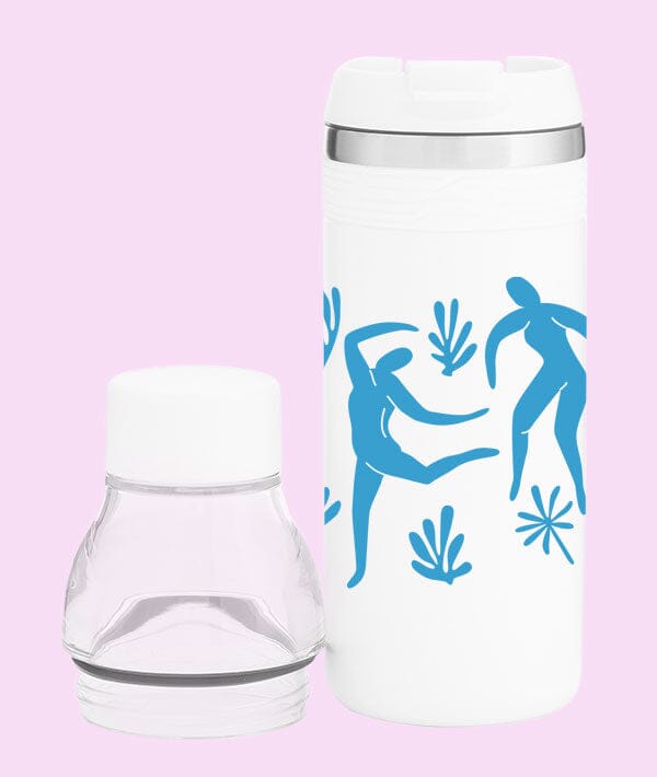White tumbler with blue abstract designs on a pink background