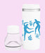White tumbler with blue abstract designs on a pink background