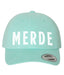 Mint green cap with 'MERDE' printed on it against a white background