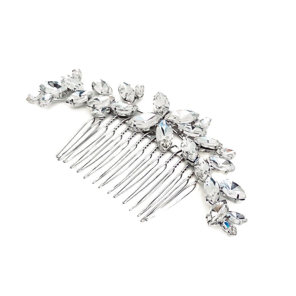 Silver hair comb with crystal stones on a white background