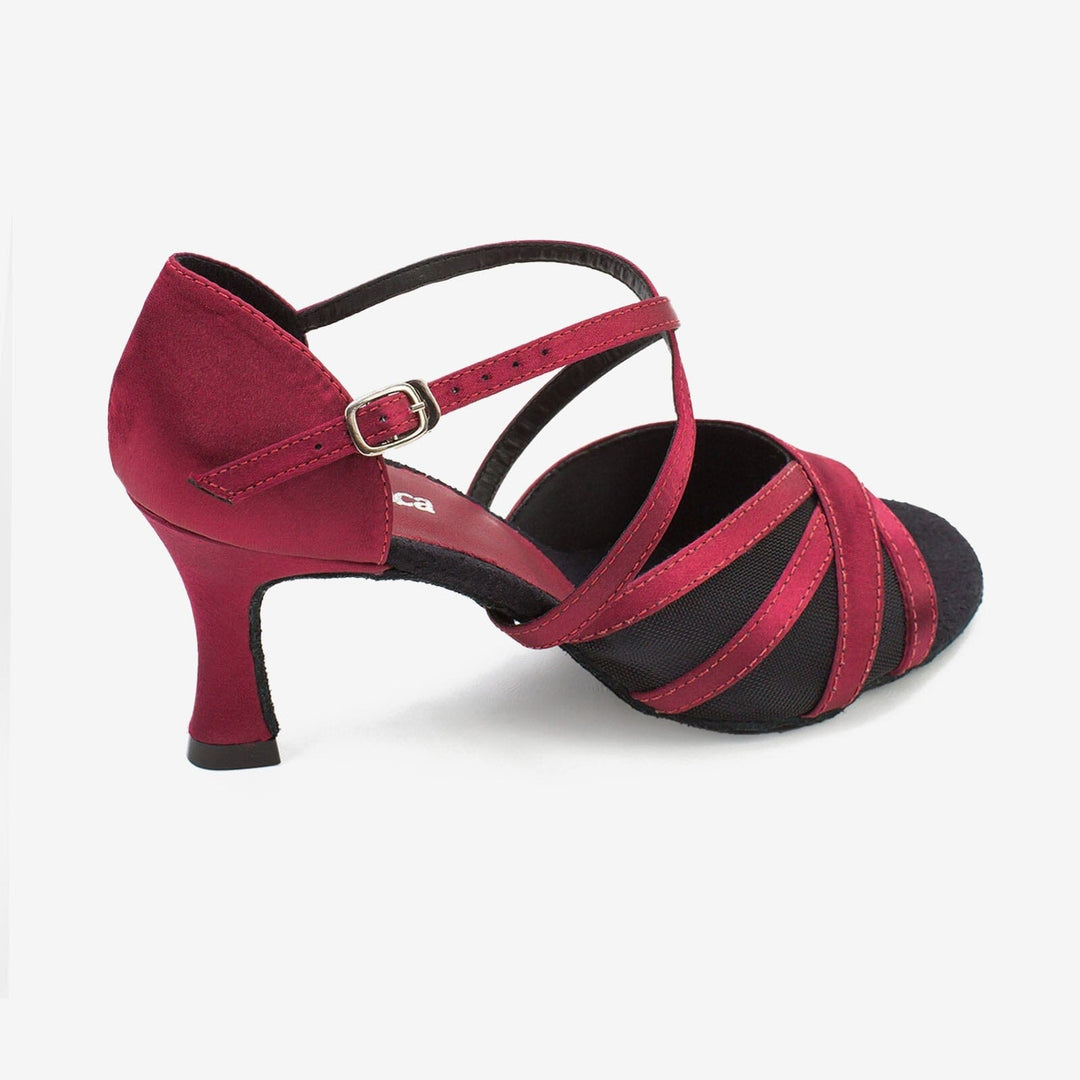 Red and black strappy shoe on a white background