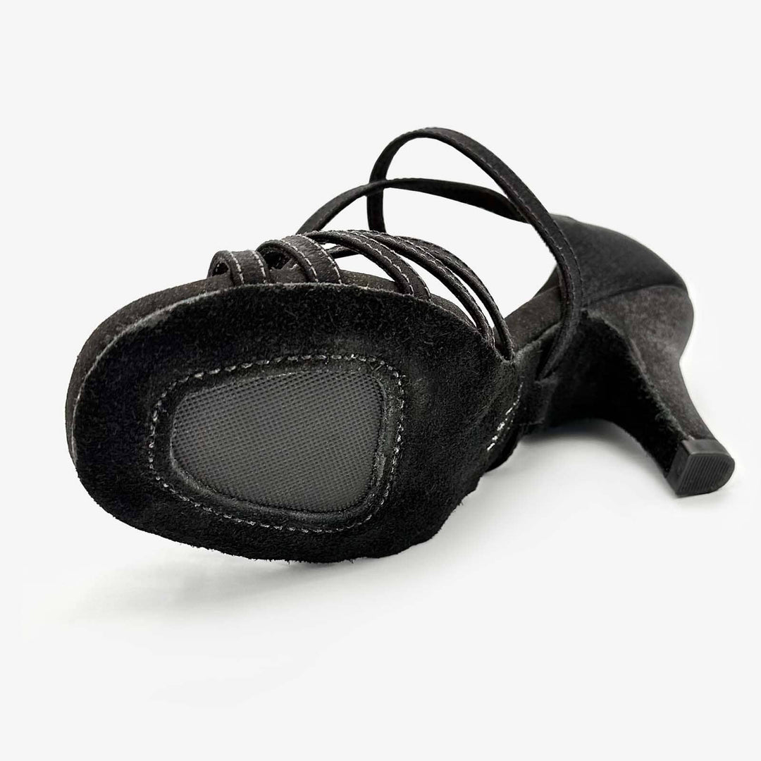 Black high-heeled shoe with strappy design on a white background