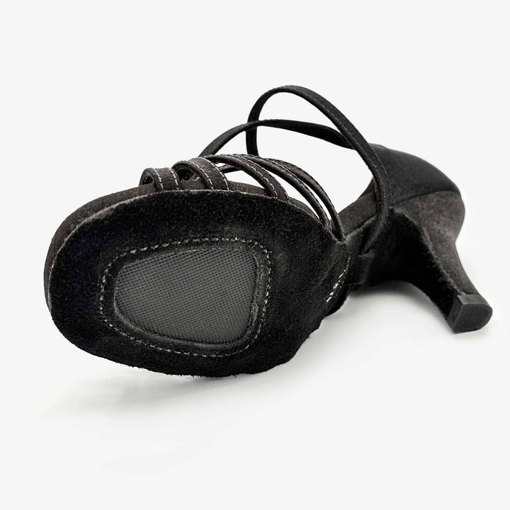 Black high-heeled shoe with strappy design on a white background