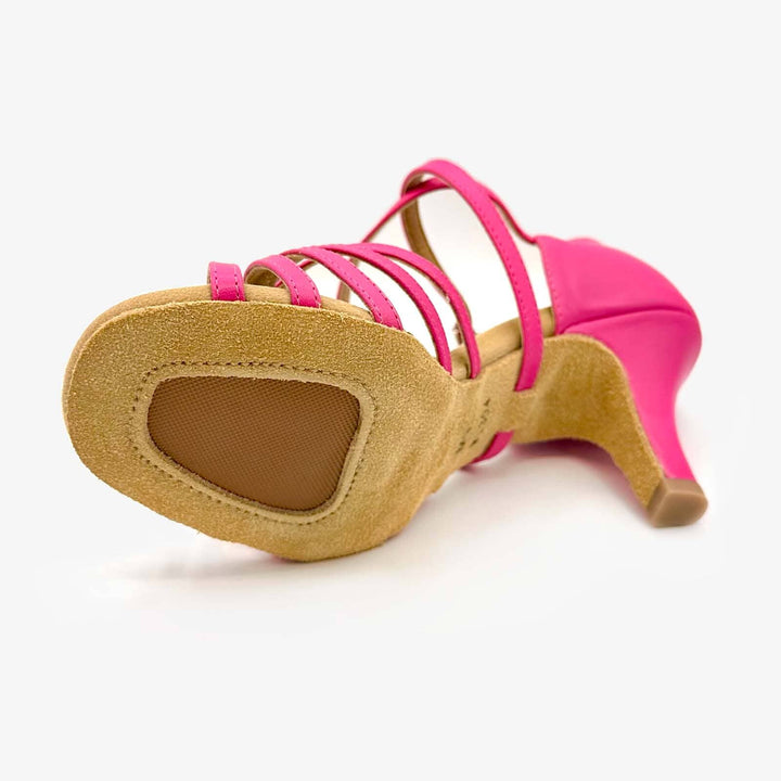 Pink high-heeled shoe with a tan sole on a white background