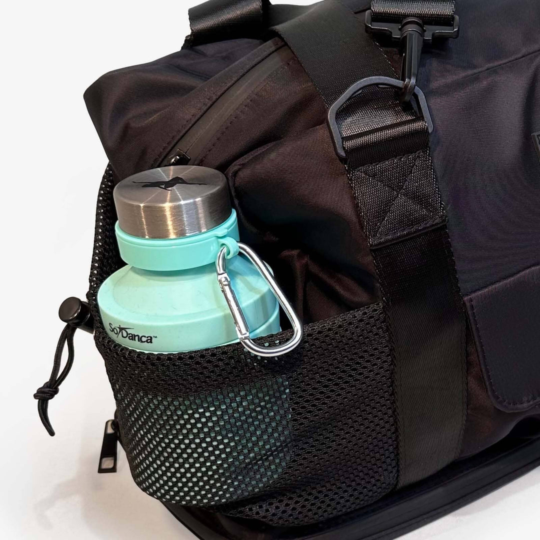 Black backpack with a turquoise water bottle attached on a white background