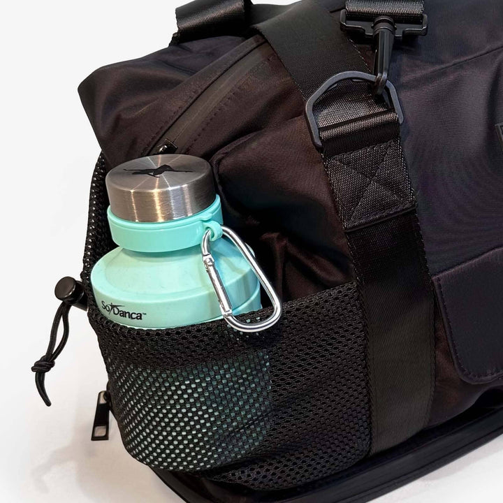 Black backpack with a turquoise water bottle attached on a white background
