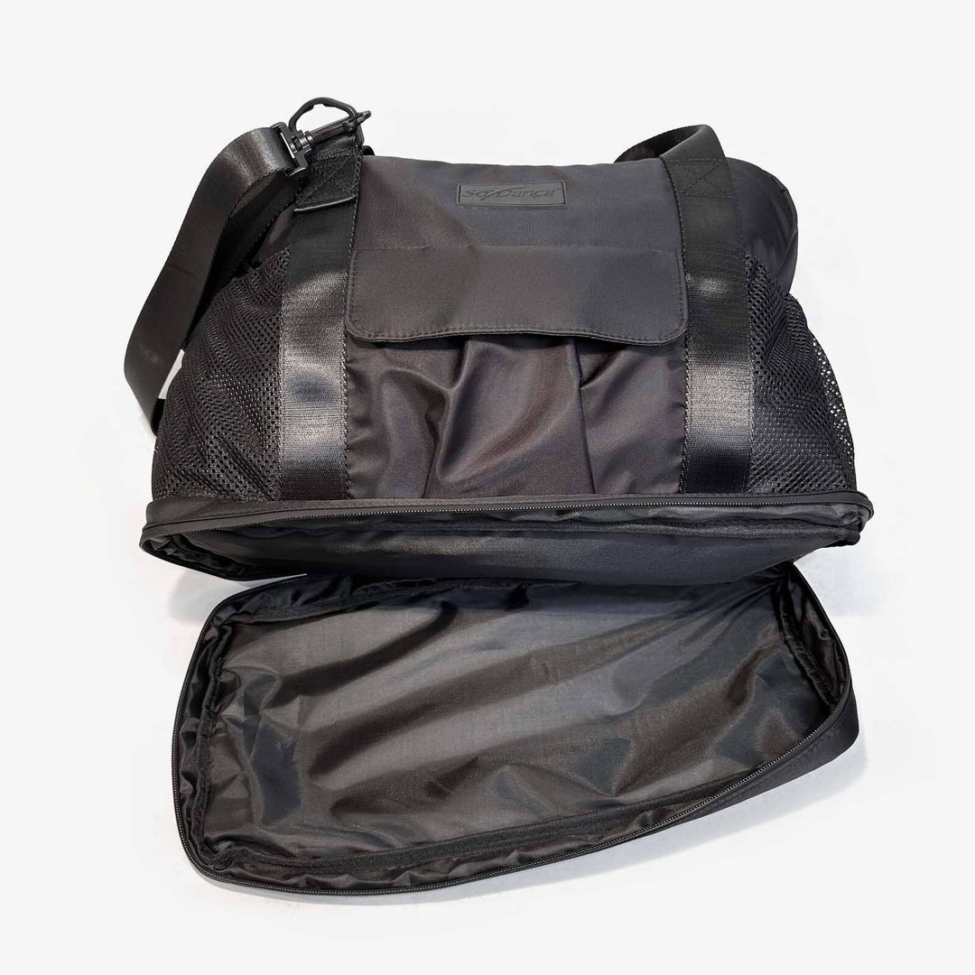 Black pet carrier with open lid on a white background