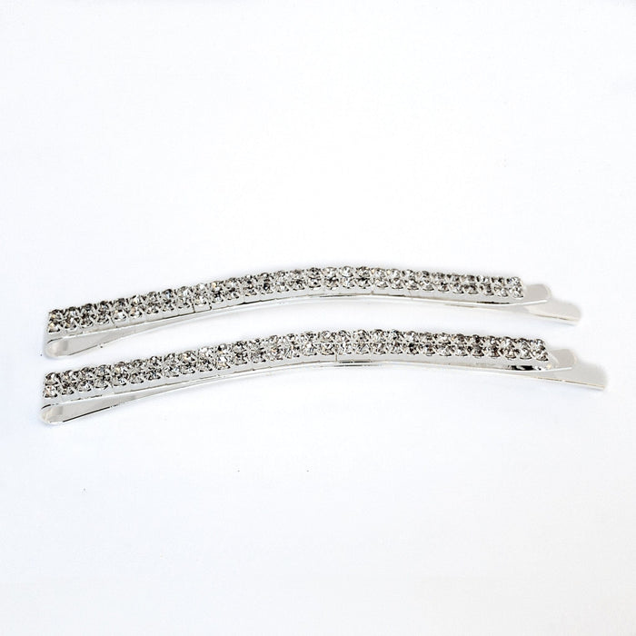 Two silver hair clips with clear rhinestones on a white background