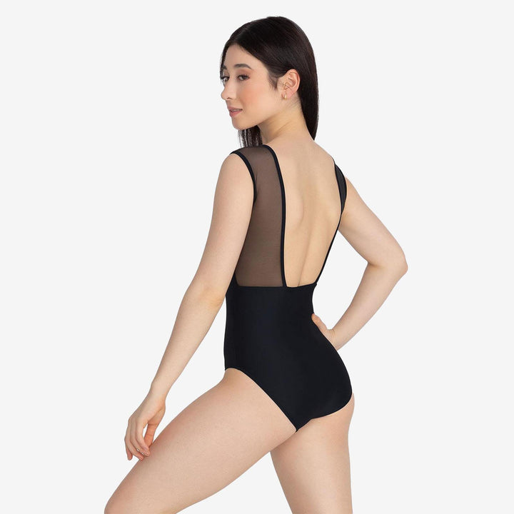 Woman wearing a black swimsuit with sheer back panels on a white background
