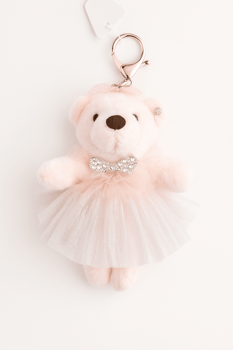 Pink teddy bear keychain with a tutu and sequin belt on a white background