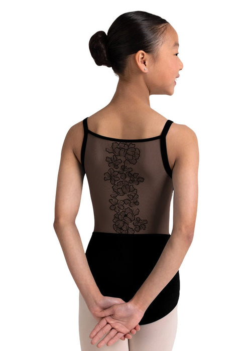 Ballet dancer wearing a black leotard with floral lace details on a white background
