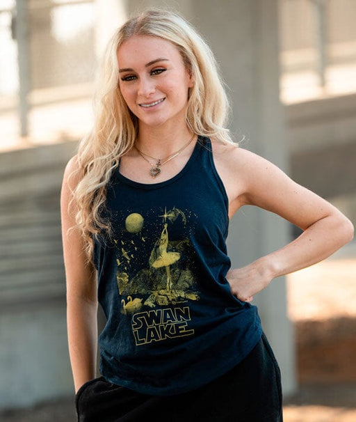 Woman wearing a navy tank top with 'Swan Lake' design outdoors.