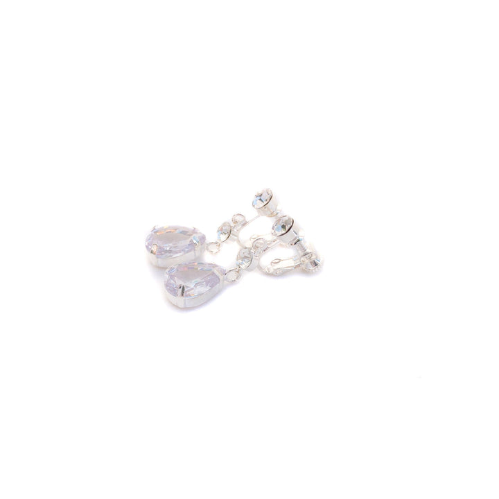 Heart-shaped earrings with clear gemstones on a white background