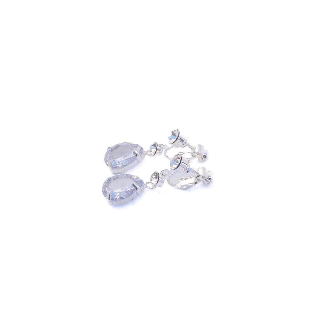 Silver earrings with clear gemstones on a white background