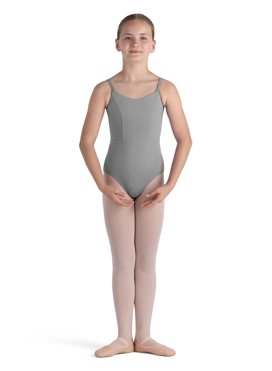 Young girl wearing a gray leotard and pink tights on a white background