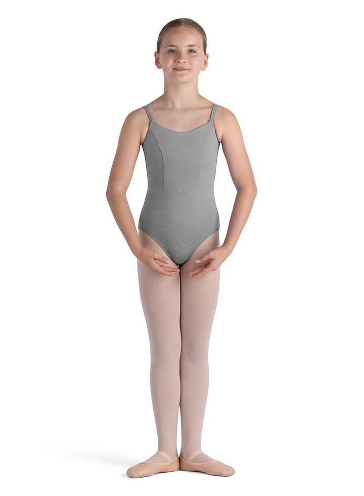 Young girl wearing a gray leotard and pink tights on a white background