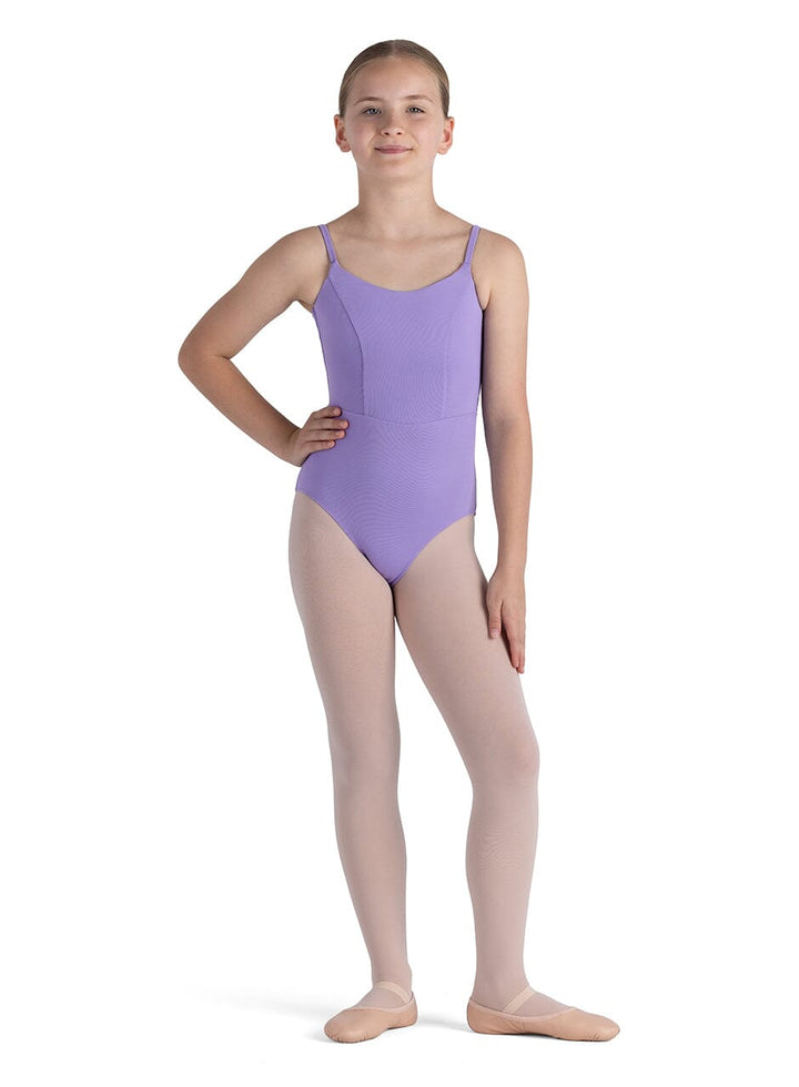 Young girl wearing a purple leotard on a white background