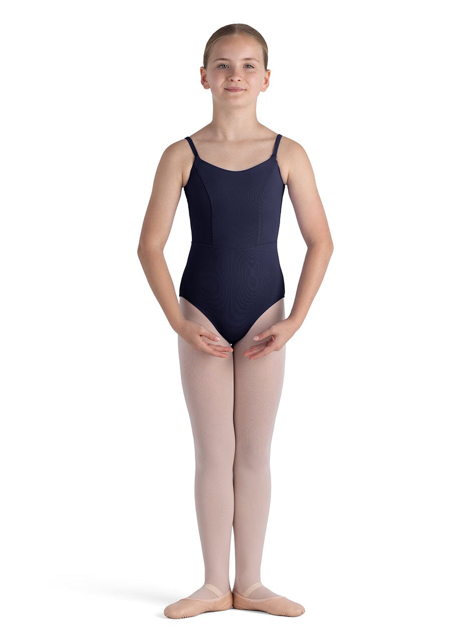 Young girl wearing a navy leotard and pink tights on a white background