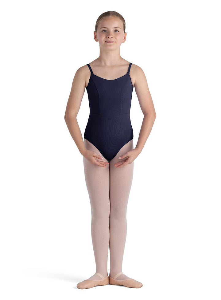 Young girl wearing a navy leotard and pink tights on a white background