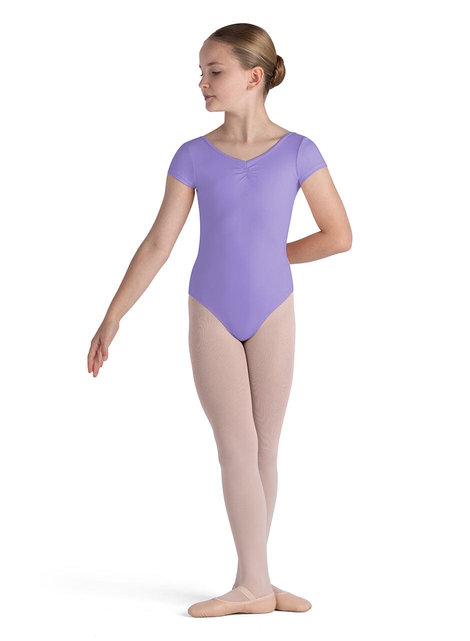Ballerina in a purple leotard on a white background