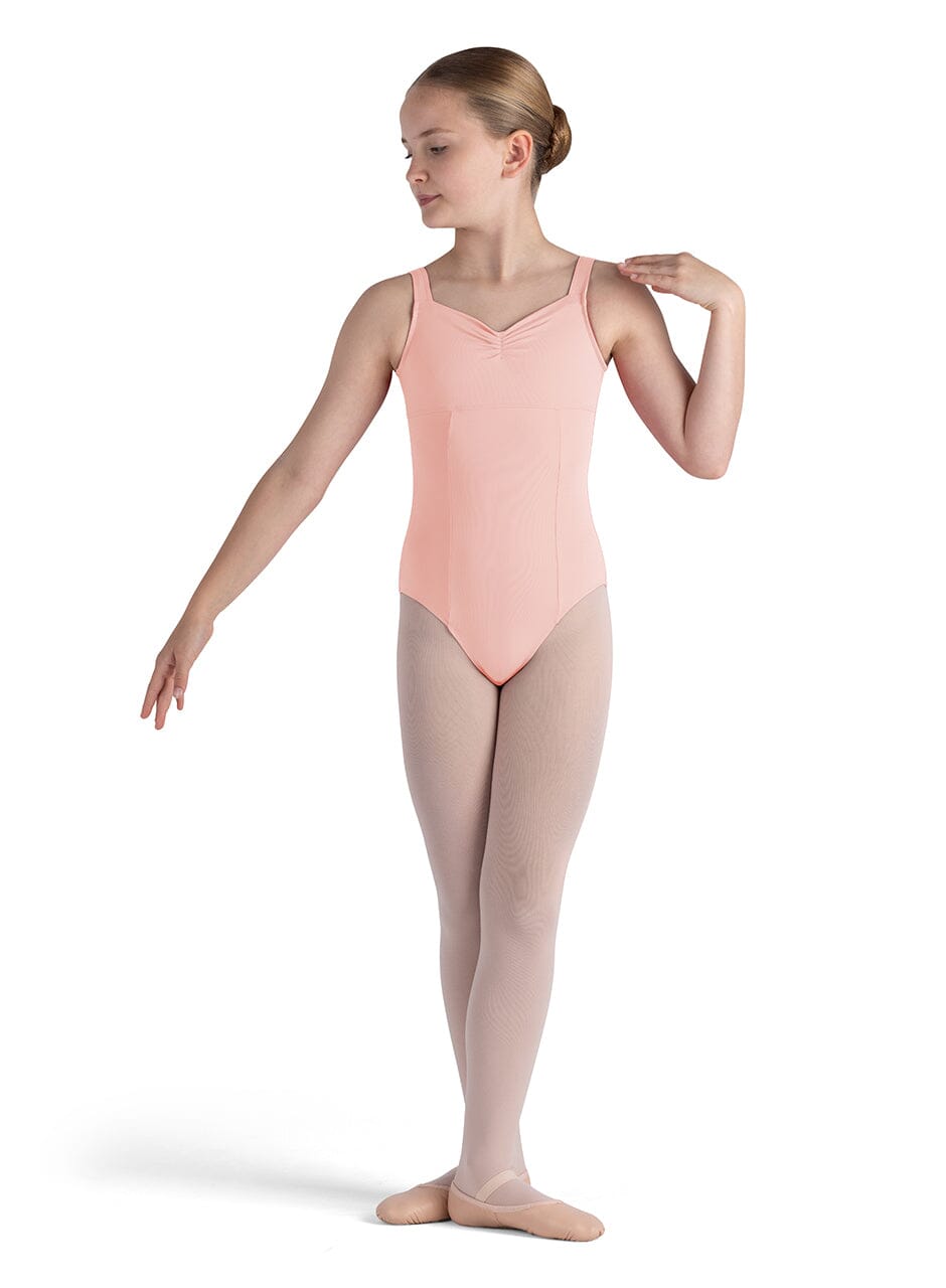Ballerina in a pink leotard and beige tights on a white background