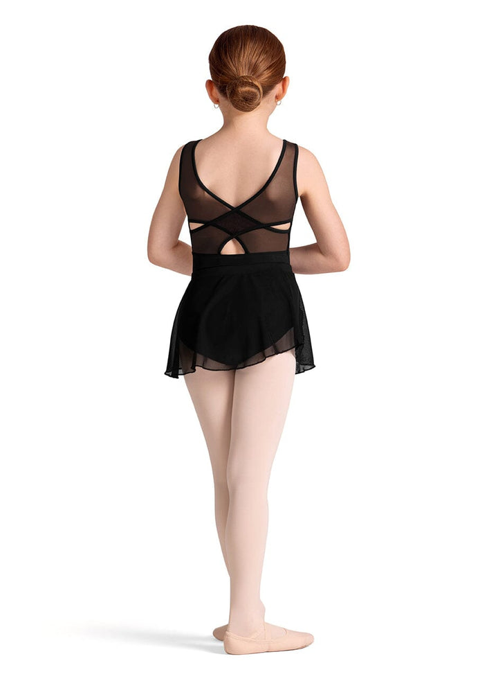 Ballerina in a black dance outfit with sheer details on a white background