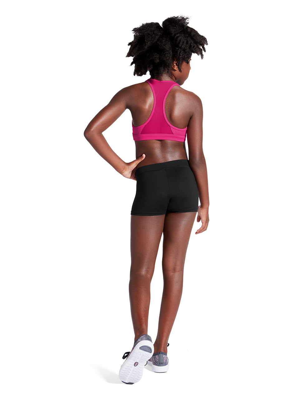 A woman shown from the back wearing a bright pink sports bra and black athletic shorts, standing on a clean white background.