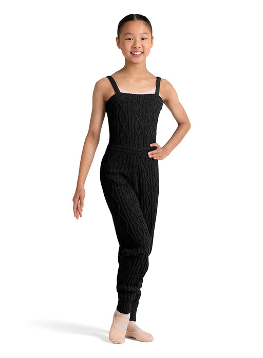 Young girl wearing a black ribbed jumpsuit on a white background