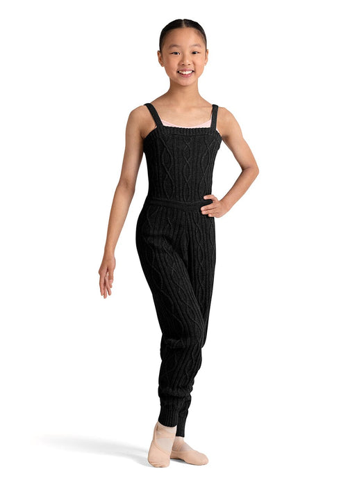 Young girl wearing a black ribbed jumpsuit on a white background